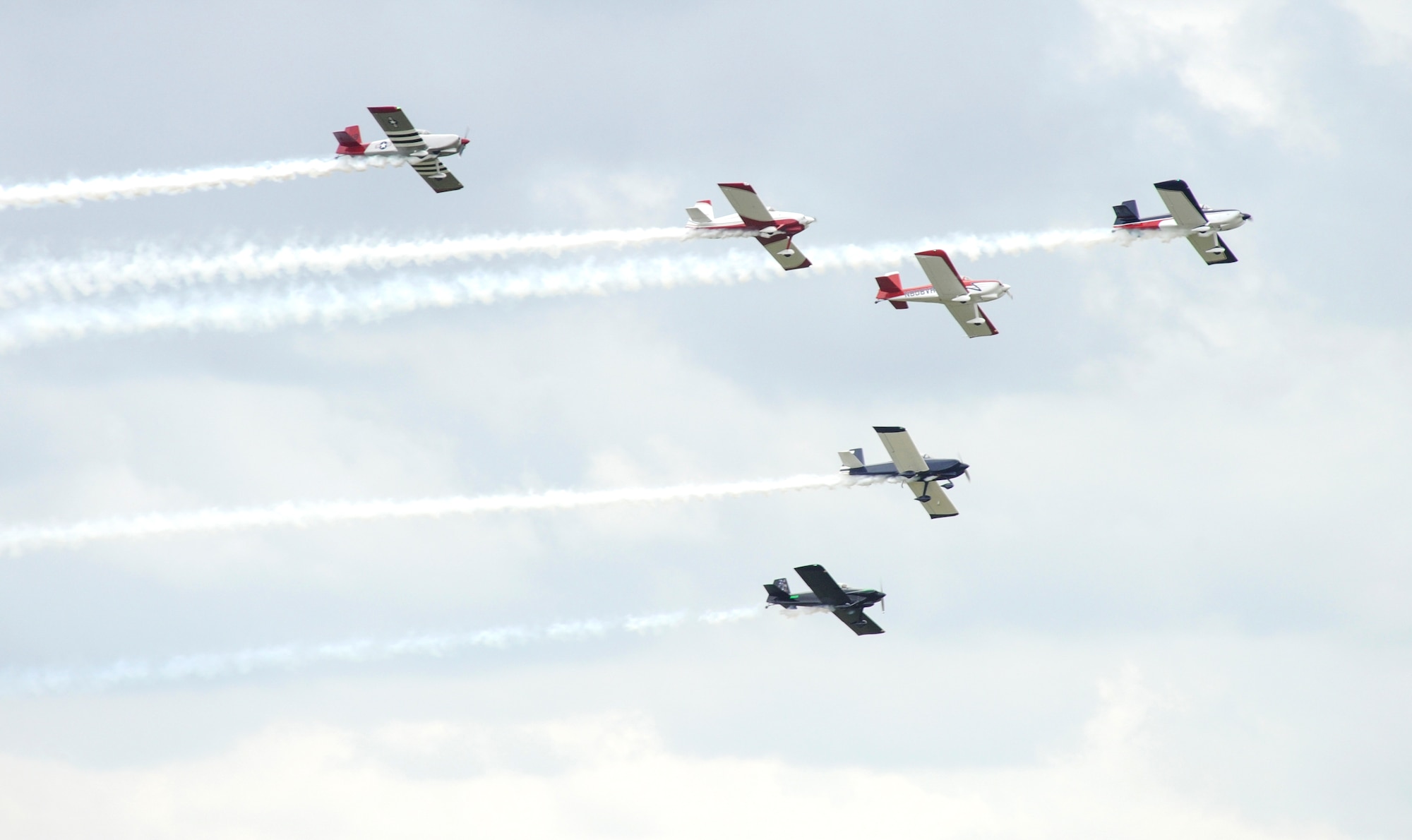 A fleet of P-51 Mustangs perform June 13, 2015, during the Wings Over Whiteman air show at Whiteman Air Force Base, Mo. The air show is a public event at which aviators display their flying skills and the capabilities of their aircraft to spectators, usually by means of aerobatics. (U.S. Air Force photo by Staff Sgt. Brigitte N. Brantley/Released) 