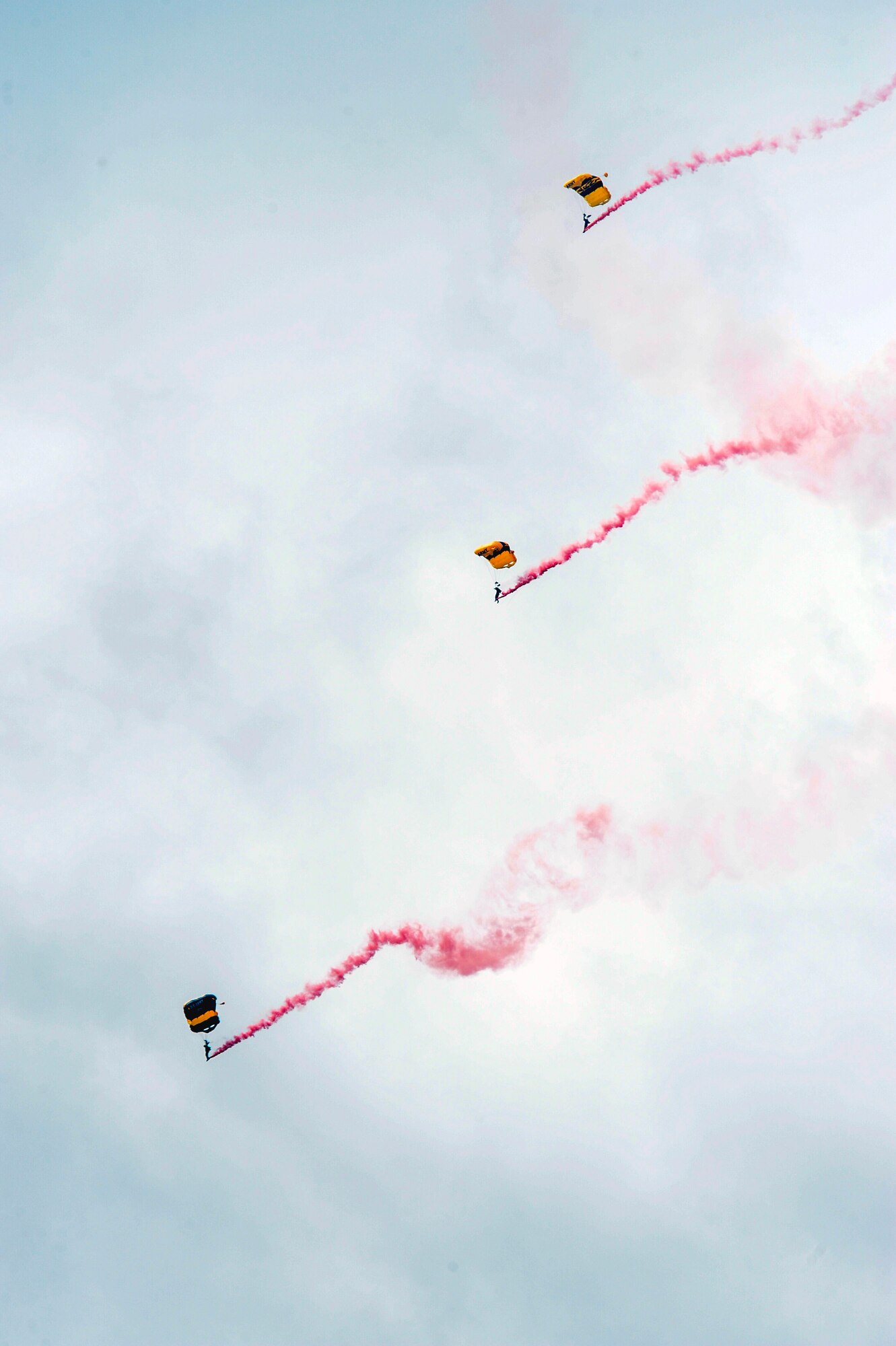 Members of the U.S. Army Golden Knights Parachute Team perform a demonstration June 13, 2015, during the Wings Over Whiteman air show at Whiteman Air Force Base, Mo. The 24 demonstrator positions on the team are typically held for at least three consecutive years. At the end of their tenure, soldiers will then either rotate back to Army units or they may request to stay with the team for an additional period of time. (U.S. Air Force photo by Staff Sgt. Brigitte N. Brantley/Released)