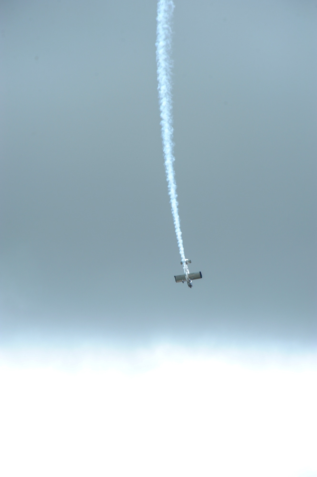 A civilian at the Wings Over Whiteman air show performs aerobatic tricks June 13, 2015, at Whiteman Air Force Base, Mo. These air shows, which let civilians and service members interact, are just one of the ways the military thanks the surrounding communities for their continued support. (U.S. Air Force photo by Staff Sgt. Brigitte N. Brantley/Released)