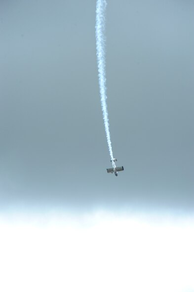 A civilian aircraft at the Wings Over Whiteman air show performs aerobatic tricks June 13, 2015, at Whiteman Air Force Base, Mo. These air shows, which let civilians and service members interact, are just one of the ways the military thanks the surrounding communities for their continued support. (U.S. Air Force photo by Staff Sgt. Brigitte N. Brantley/Released) 