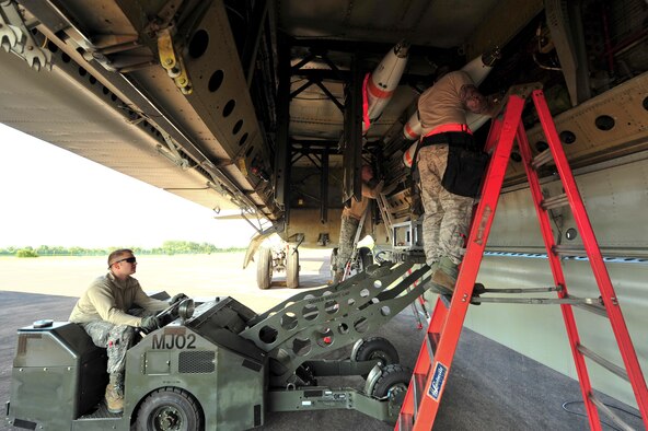 Load crew members from the 5th Aircraft Maintenance load an inert MK-62 Quick Strike Mine into a B-52H Stratofortress at Royal Air Force Fairford, England, June 11, 2015. U.S. Navy minemen, from Navy Munitions Command Unit Charleston, worked with Airmen from the 5th Munitions Squadron to build the munitions, which were used in a BALTOPS 15 training scenario by the B-52H Stratofortress and its crew. BALTOPS demonstrates America’s shared commitment with NATO allies and partners to promote peace and security in the region. (U.S. Air Force photo/Senior Airman Malia Jenkins)    