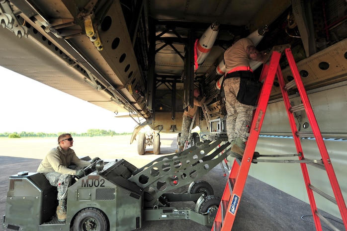Load crew members from the 5th Aircraft Maintenance load an inert MK-62 Quick Strike Mine into a B-52H Stratofortress at Royal Air Force Fairford, England, June 11, 2015. U.S. Navy minemen, from Navy Munitions Command Unit Charleston, worked with Airmen from the 5th Munitions Squadron to build the munitions, which were used in a BALTOPS 15 training scenario by the B-52H Stratofortress and its crew. BALTOPS demonstrates America’s shared commitment with NATO allies and partners to promote peace and security in the region. (U.S. Air Force photo/Senior Airman Malia Jenkins)    