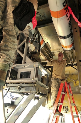 Staff Sgt. Jason Walters, 5th Aircraft Maintenance Squadron weapons load crew chief, and Senior Airman Zachary Kienert, 5th AMXS weapons load crew member, load an inert MK-62 Quick Strike Mine into a B-52H Stratofortress at Royal Air Force Fairford, England, June 11, 2015. U.S. Navy minemen, from Navy Munitions Command Unit Charleston, worked with Airmen from the 5th Munitions Squadron, to build the munitions, which were used in the BALTOPS 15 exercise by the B-52H Stratofortress and its crew. BALTOPS demonstrates America’s shared commitment with NATO allies and partners to promote peace and security in the region. (U.S. Air Force photo/Senior Airman Malia Jenkins)   