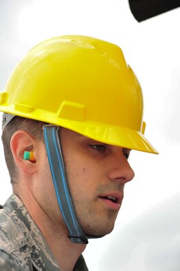 U.S. Air Force Staff Sgt. Ryan Cassady, 5th Munitions Squadron munitions system technician, guides an inert MK-62 Quick Strike Mine body onto a trailer during a mine build at Royal Air Force Fairford, England, June 10, 2015. Members from 5th MUNS helped U.S. Navy minemen build 18 inert mines for a  BALTOPS 15 exercise testing the B-52H Stratofortress’ ability to precisely drop munitions into a target zone off the coast of Sweden. (U.S. Air Force photo/Senior Airman Malia Jenkins)      