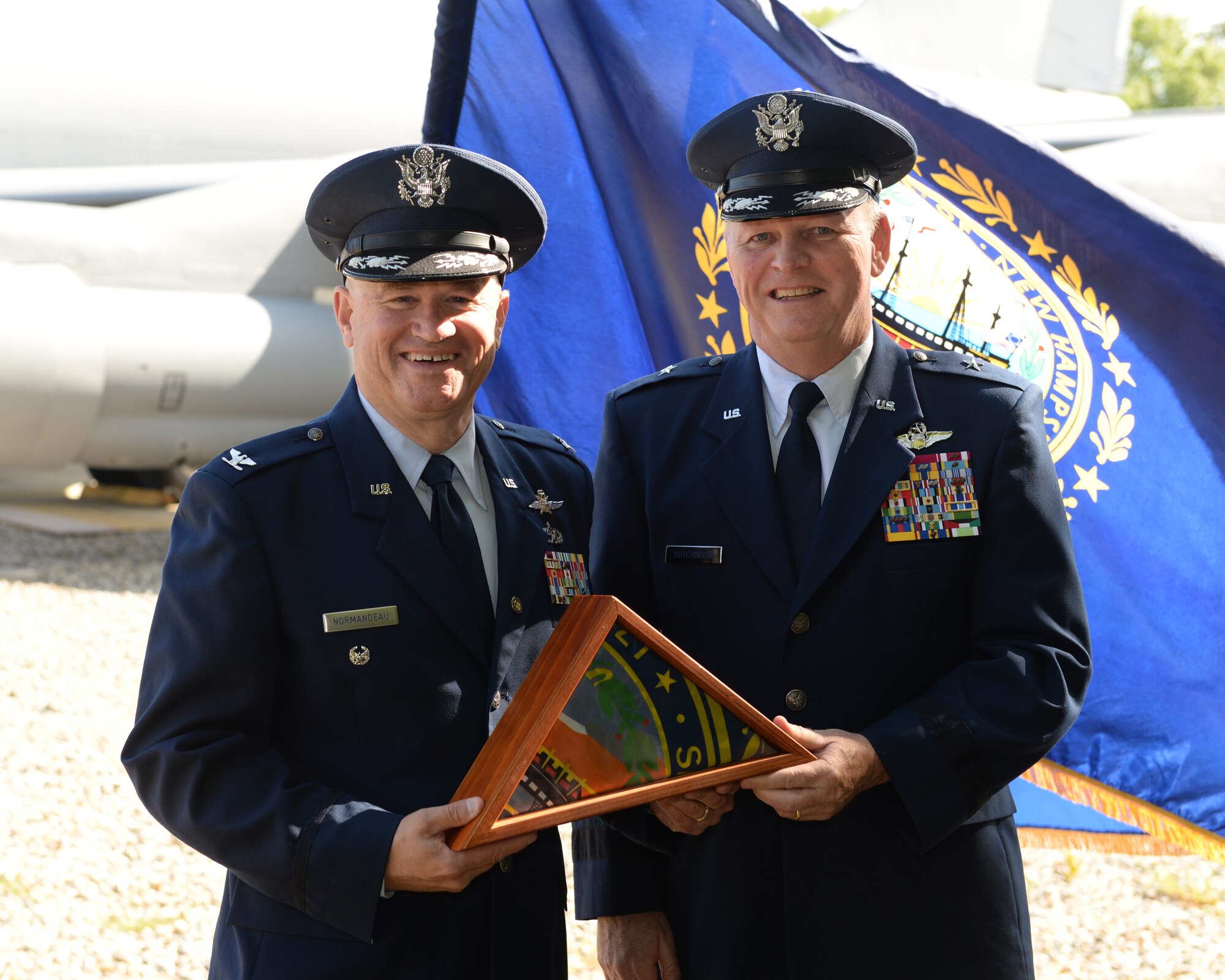 Brig. General Paul Hutchinson (right), N.H. Air National Guard chief of staff, presents former N.H. Air National Guard member, Col. Scott Normandeau a N.H. state flag during the colonel’s retirement ceremony here June 14. Normandeau retires with 30 years of service to the United States Air Force and Air National Guard. (U.S. Air National Guard photo by Staff Sgt. Curtis J. Lenz)