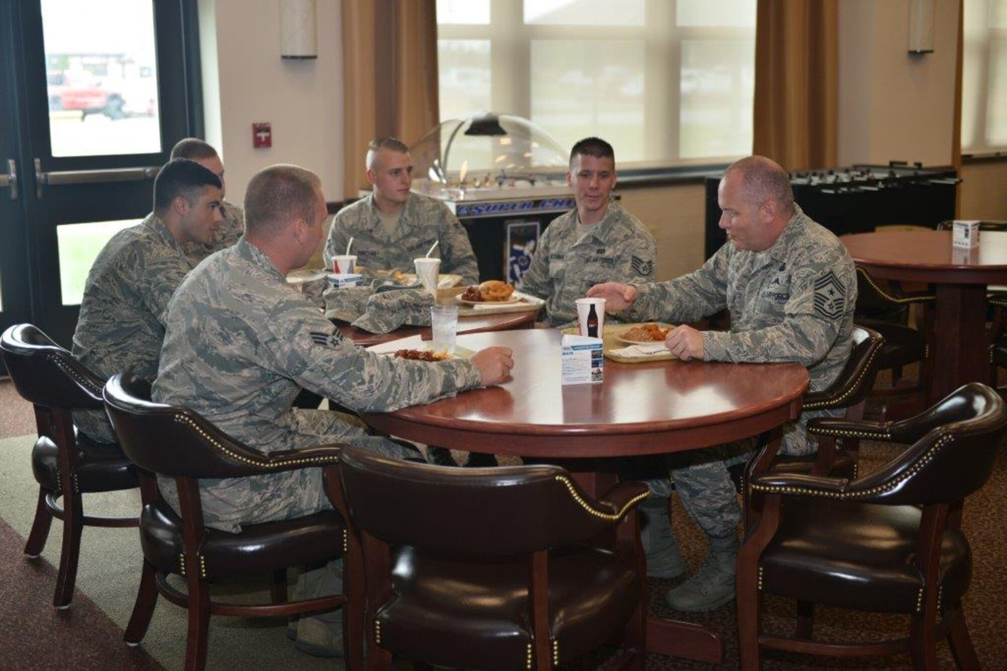 Command Chief Master Sergeant of the Air National Guard, James W. Hotaling (right) has lunch at Niagara Falls Air Reserve Station on June 14, 2015 with Senior Airman John Guiher, Airmen 1st Class Michael Giordano, Airman 1st Class Jared Hicks, Airman 1st Class Joshua Yurchek, and Staff Sergeant Christopher McKimmie to thank them for saving a man from drowning (U.S. Air National Guard photo by Staff Sgt. Ryan Campbell).