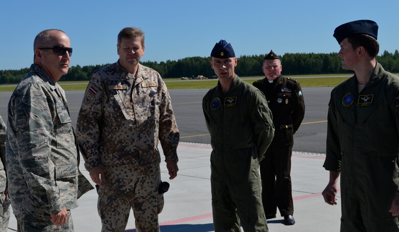 Brig. Gen. John D. Slocum, 127th Wing commander, Michigan Air National Guard is greeted by a Latvian Air Force crew just before getting on board a MI-17 helicopter at Lielvarde Air Base, Latvia on June 12. Slocum is being transported to Rezekne, to be a guest of honor in a Latvian National Guard change of command ceremony. The Michigan National Guard is part of a Department of Defense sponsored State Partnership Program between Michigan and the Latvian government that began in 1993 being one of the models for an ongoing program that has united 68 unique security partnerships involving 74 nations around the globe. The 127th Wing is participating in Saber Strike, an annual exercise that has brought 14 ally and partner nations together to increase interoperability between military forces. (U.S. Air National Guard photo by Capt. Anthony J. Lesterson)