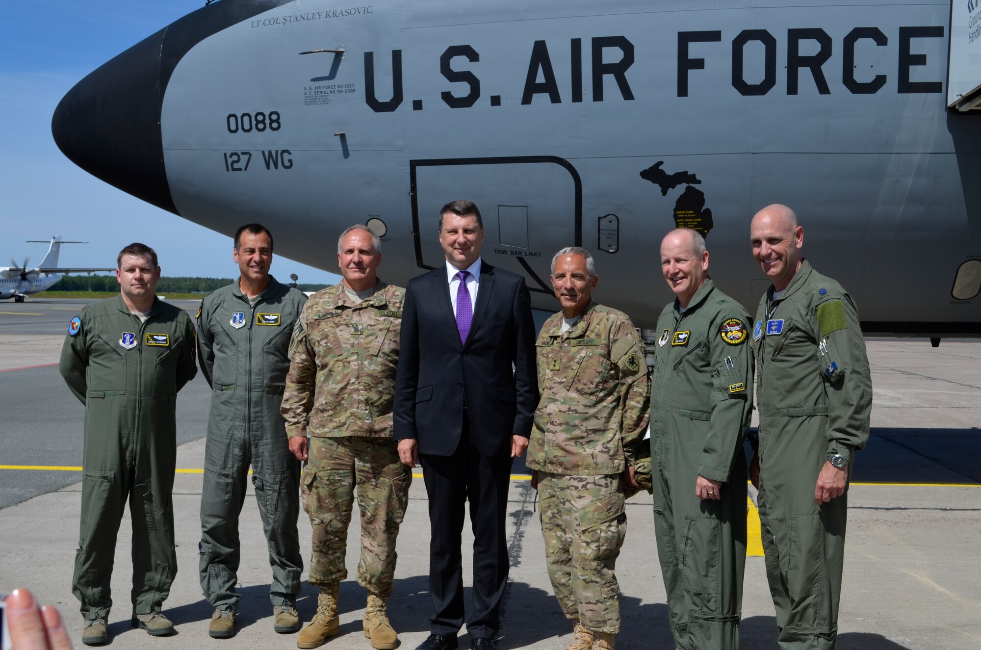 Key members of the Michigan National Guard pose with newly appointed Latvian president during the Latvian Partnership Day on June 10, 2015. Starting from the left: Maj. Deryck Castonguay, and Lt. Col. Jon Wiesinger, both 171st Air Refueling Squadron pilots, Michigan State Command Sergeant Major, Dan Lincoln, newly elected Latvian President, Raimods Veonis, Maj. Gen. Gregory J. Vadnais, Adjutant General of the Michigan National Guard, Brig. Gen. John D. Slocum, 127th Wing commander, Michigan Air National Guard, and Lt. Col. Timothy Brock, Michigan Air National Guard member serving as the bilateral affairs officer for the U.S. Embassy. The DOD sponsored State Partnership Program between Michigan and the Latvian government began in 1993 being one of the models for an ongoing program that has united 68 unique security partnerships involving 74 nations around the globe. Exercise Saber Strike 15 has brought 14 ally and partner nations together to increase interoperability between military forces. (U.S. Air National Guard photo by Capt. Anthony J.Lesterson) 
