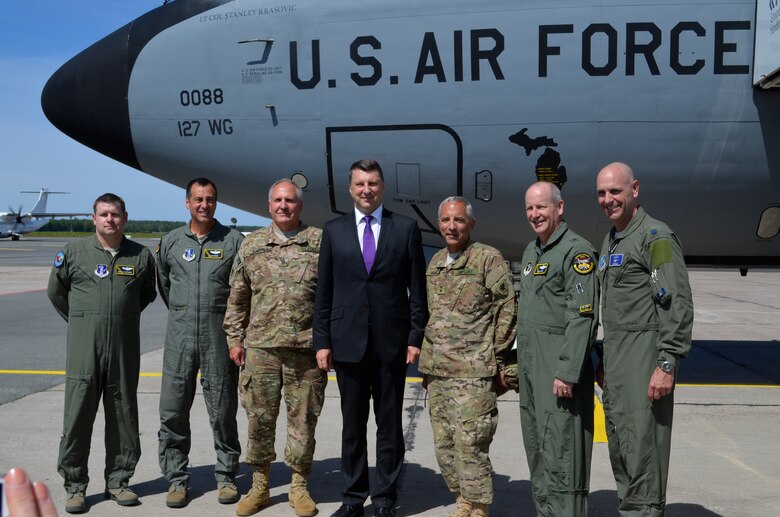 Key members of the Michigan National Guard pose with newly appointed Latvian president during the Latvian Partnership Day on June 10, 2015. Starting from the left: Maj. Deryck Castonguay, and Lt. Col. Jon Wiesinger, both 171st Air Refueling Squadron pilots, Michigan State Command Sergeant Major, Dan Lincoln, newly elected Latvian President, Raimods Veonis, Maj. Gen. Gregory J. Vadnais, Adjutant General of the Michigan National Guard, Brig. Gen. John D. Slocum, 127th Wing commander, Michigan Air National Guard, and Lt. Col. Timothy Brock, Michigan Air National Guard member serving as the bilateral affairs officer for the U.S. Embassy. The DOD sponsored State Partnership Program between Michigan and the Latvian government began in 1993 being one of the models for an ongoing program that has united 68 unique security partnerships involving 74 nations around the globe. Exercise Saber Strike 15 has brought 14 ally and partner nations together to increase interoperability between military forces. (U.S. Air National Guard photo by Capt. Anthony J.Lesterson) 
