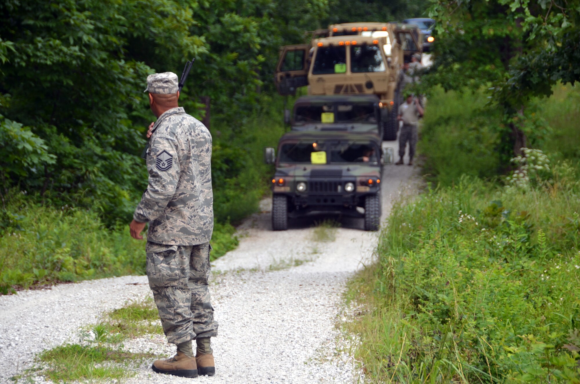 Master Sgt. Ervin Lockhart, a radio frequency technician with the 239th Combat Communications Squadron, directs his team after they move simulated barriers out of the way of their convoy, June 4, 2015.  Lockhart served as the convoy and incident commander during a mass casualty exercise.  
(U.S. Air National Guard photo by Tech.  Sgt. Traci Payne)