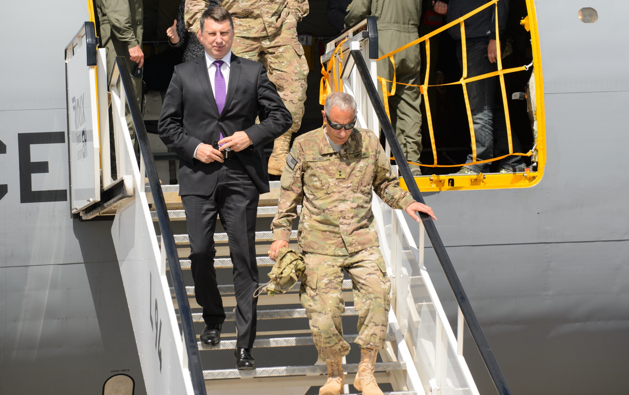 U.S. Army Maj. Gen. Gregory Vadnais, Michigan National Guard Adjutant General, and Raimonds Vējonis, Latvian president elect, exit a Michigan Air National Guard KC-135 Stratotanker June 10, 2015, at Riga International Airport, Latvia. U.S. National Guardsmen hosted the Latvian president elect and several distinguished visitors during exercise Saber Strike 15. The visitors were able to view up-close how the Michigan and Pennsylvania Air National Guard conduct aerial-refueling and support ground troops by refueling a Maryland ANG A-10 Thunderbolt II. (U.S. Air Force photo/ Staff Sgt. Armando Schwier-Morales)