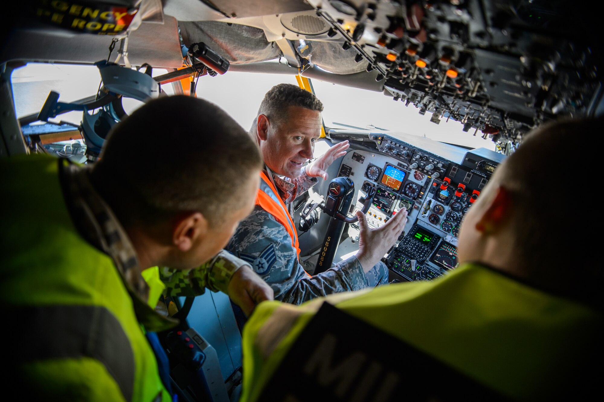 Staff Sgt. Kenneth Stokley, 191st Aircraft Maintenance Squadron crew chief, gives a tour of a KC-135 Stratotanker to Latvian Air Forces military policemen during the Michigan-Latvia Partnership Day June 10, 2015 at Riga International Airport Latvia. U.S. National Guardsmen hosted the Latvian president elect and several distinguished visitors during exercise Saber Strike 15. The visitors were able to view up-close how the Michigan and Pennsylvania Air National Guard conduct aerial-refueling and support ground troops by refueling a Maryland ANG A-10 Thunderbolt II. (U.S. Air Force photo/ Staff Sgt. Armando Schwier-Morales)