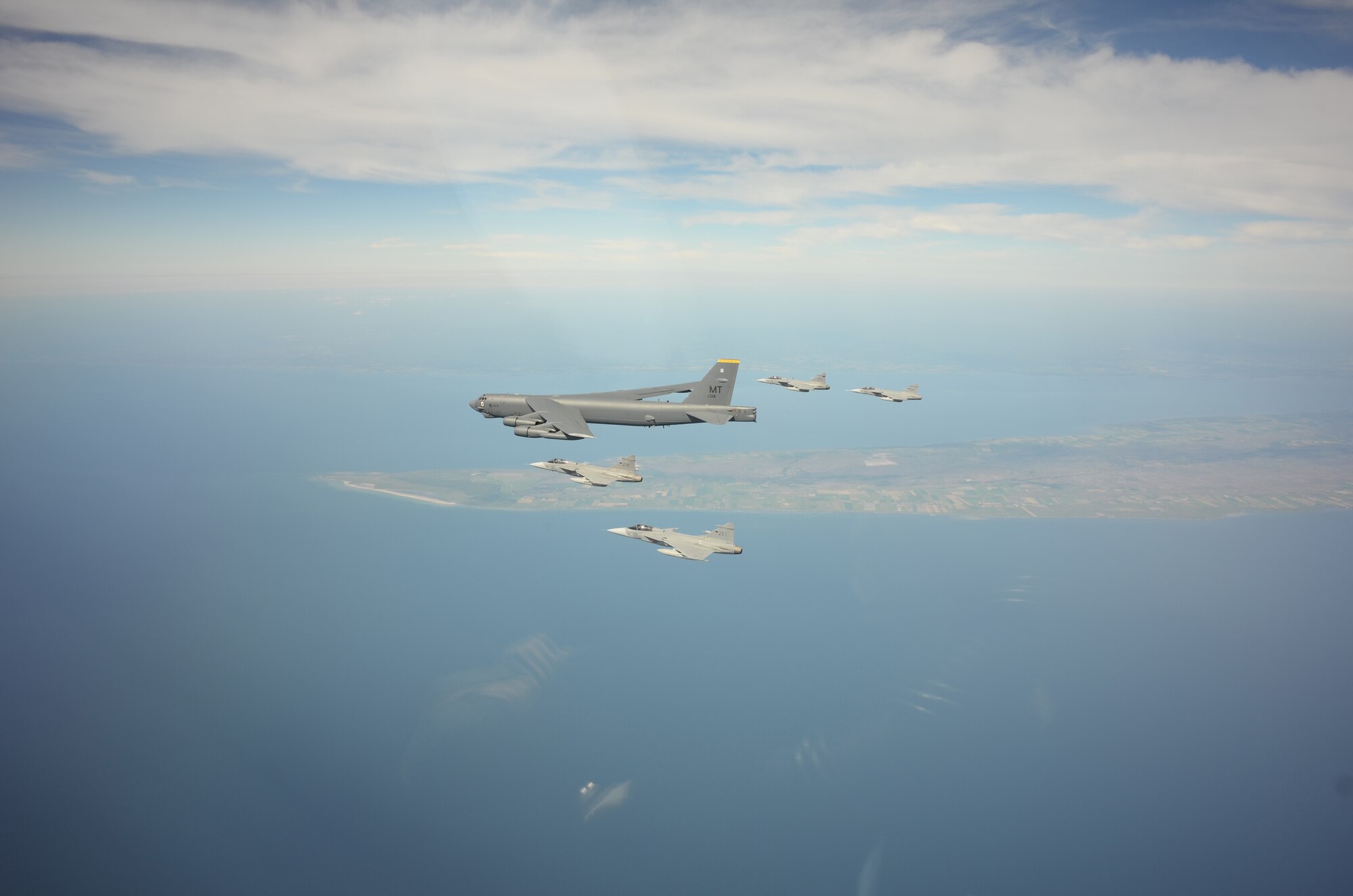 A U.S. Air Force B-52H Stratofortress leads a flight of four Swedish JAS-39 Gripens June 11, 2015, during a BALTOPS 2015 mission over the Baltic Sea. The aircraft took part in multiple missions throughout the exercise, including MK-62 Quick Strike mine drops and naval support functions. During this part of the exercise, the two airframes practiced aircraft intercepts and formation flights to hone skills between pilots from different countries. (Swedish Armed Forces courtesy photo)