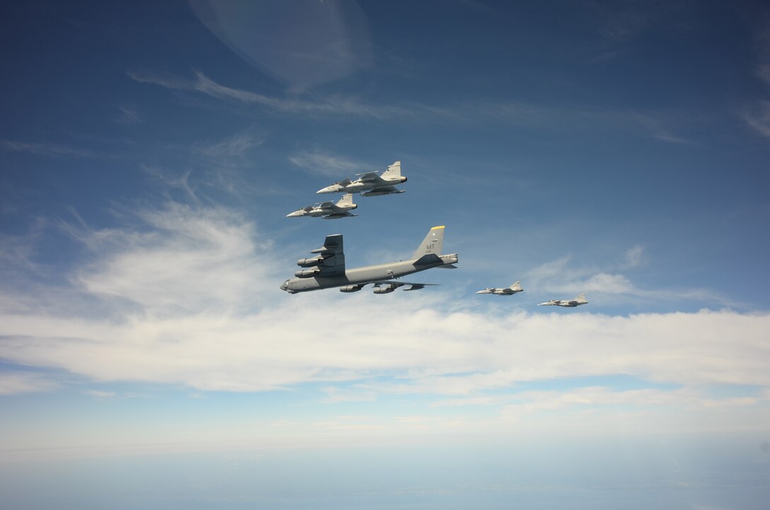 A U.S. Air Force B-52H Stratofortress leads a flight of four Swedish JAS-39 Gripens June 11, 2015, during a BALTOPS 2015 mission over the Baltic Sea. The aircraft took part in multiple missions throughout the exercise, including MK-62 Quick Strike mine drops and naval support functions. During this part of the exercise, the two airframes practiced aircraft intercepts and formation flights to hone skills between pilots from different countries. (Swedish Armed Forces courtesy photo)