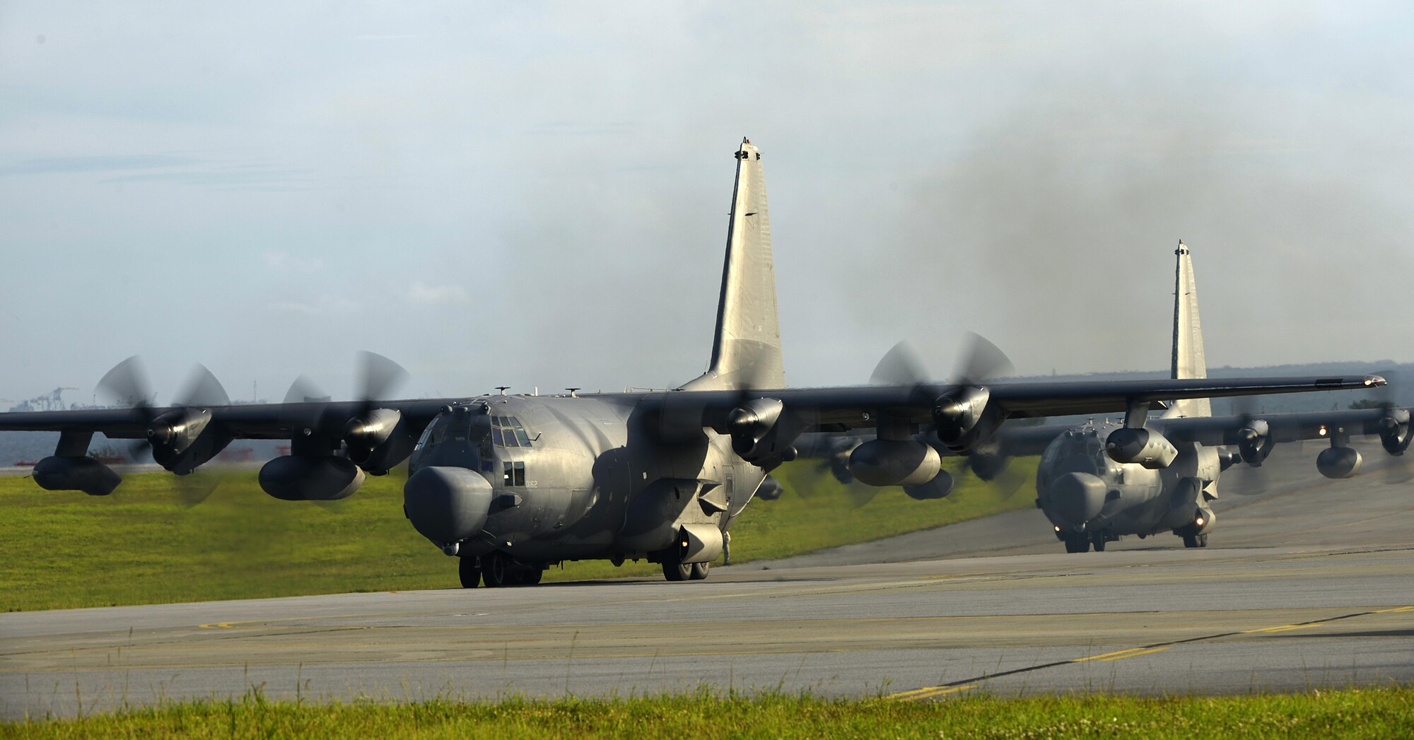 Two U.S. Air Force MC-130H Combat Talon IIs from the 1st Special Operations Squadron taxi in line on the Kadena Air Base, Japan, flightline May 14, 2015. The 1st Special Operations Squadron operates the MC-130H providing infiltration, exfiltration, and resupply of special operations forces and equipment in hostile or denied territory.  By conducting formation flight, aircrews and maintainers test and validate their ability to efficiently generate aircraft and to quickly infiltrate and exfiltrate large numbers of ground forces. (U.S. Air Force photo by Staff Sgt. Maeson L. Elleman)