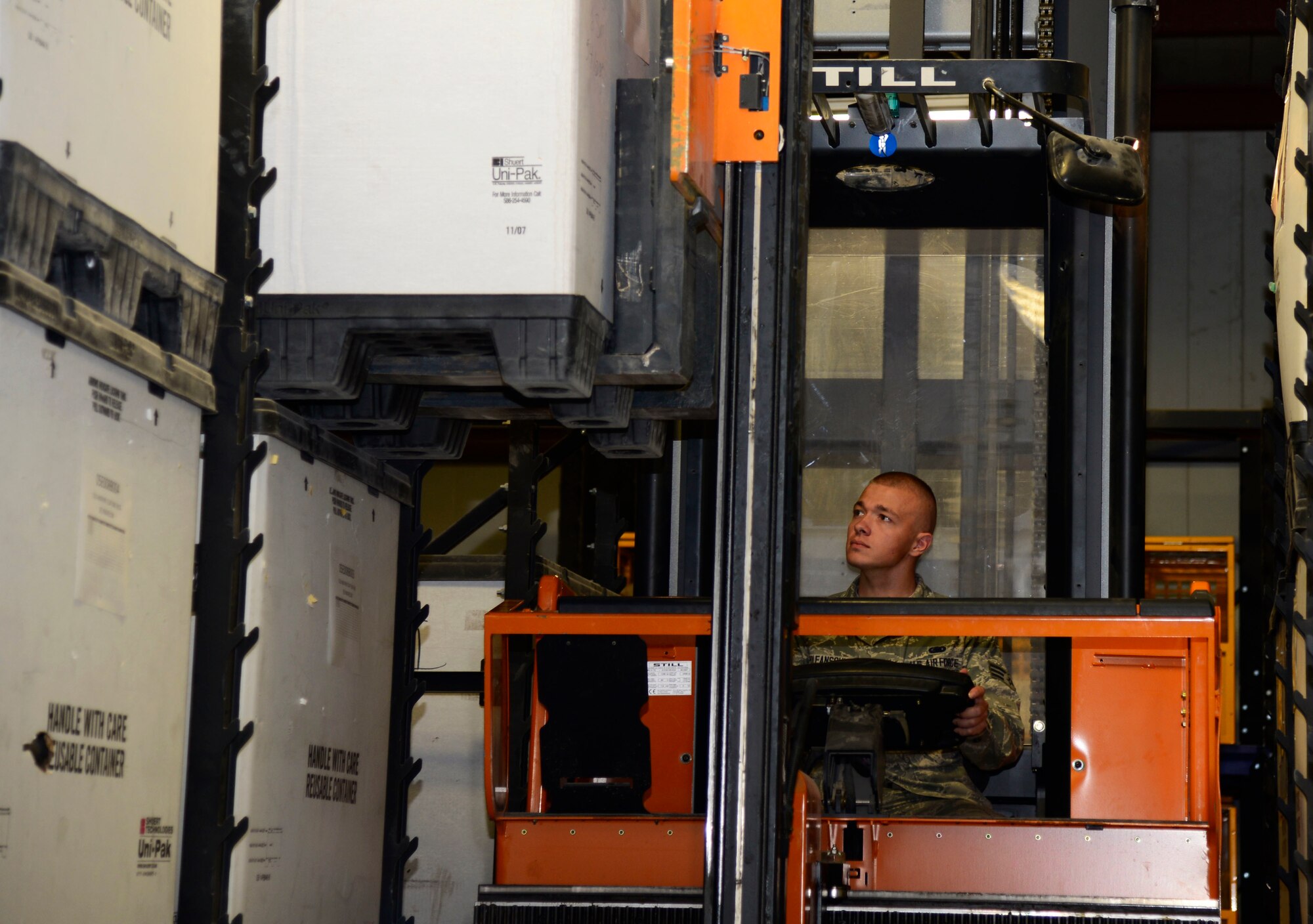 U.S. Air Force Senior Airman Vadim Poleanschi, a 386th Expeditionary Logistic Readiness Squadron logistic specialist, uses a forklift to move a pallet at an undisclosed location in Southwest Asia on June 3, 2015. Logistic specialist supplies aircraft with parts and personnel with equipment to carry out the mission downrange. (U.S. Air Force photo by Senior Airman Racheal E. Watson/Released)