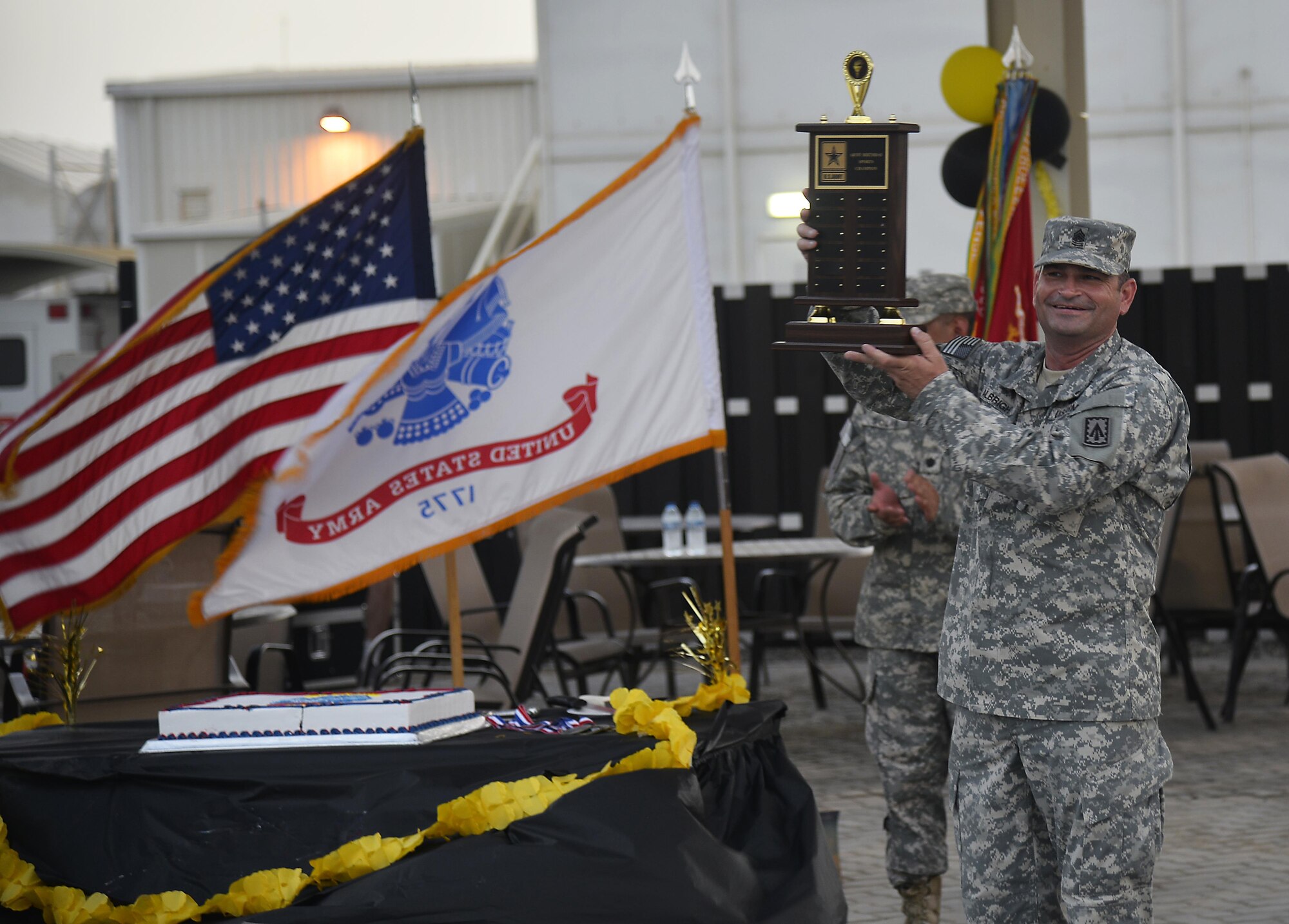Command Sgt. Maj. Paul Albright, 1st Battalion, 7th Air Defense Artillery Regiment command sergeant major, holds up the Army birthday cup at an undisclosed location in Southwest Asia June 13, 2015. The Army was awarded the cup for being the top overall team during the two-day, five-sport U.S. Army birthday competition. (U.S. Air Force photo/Tech. Sgt. Jeff Andrejcik)