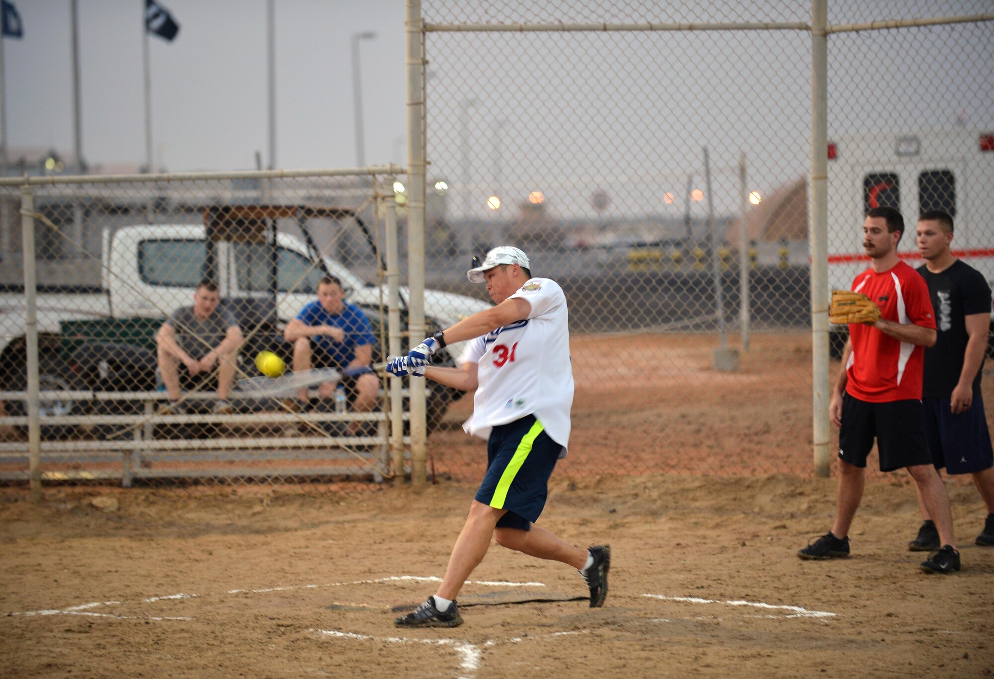 Capt. Jimi, chief of protocol, swings at a softball during a two-day sporting event celebrating the U.S. Army’s 240th birthday at an undisclosed location in Southwest Asia June 13, 2015. The two-day festivities saw U.S. Soldiers and Airmen as well as other coalition forces participate in a 5K color run, volleyball, softball, tug-o-war and dodgeball. (U.S. Air Force photo/Tech. Sgt. Jeff Andrejcik)