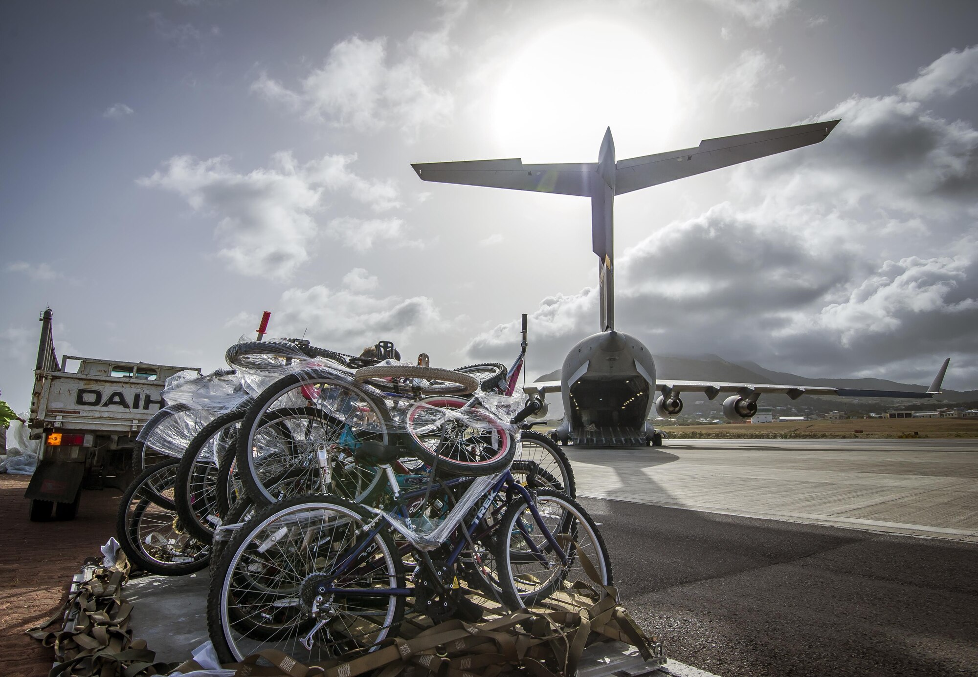 A C-17 Globemaster III delivers humanitarian aid to the citizens of Saint Kitts and Nevis June 13, 2015, making it the first 315th Airlift Wing mission to fly into Saint Kitts. In addition to bicycles, school and medical supplies were delivered and prior to the delivery in Saint Kitts, more than 65,000 pounds of food was brought to the citizens of Haiti. (U.S. Air Force photo by Senior Airman Tom Brading)