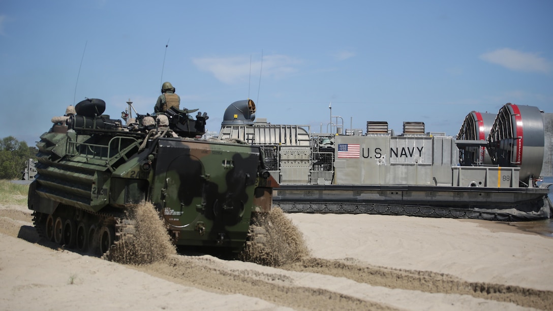 Marines with Charlie Company, 1st Battalion, 6th Marine Regiment ride in amphibious assault vehicles as they drive on a beach in Sweden for a two-day training operation during BALTOPS 2015 June 11, 2015. Marine Corps from Sweden, Finland, the U.K. and U.S. made up the amphibious assault force during BALTOPS 2015, an annual exercise with 17 NATO and partner nations.