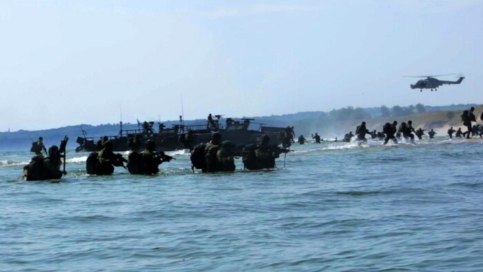 An international Corps of Marines from Sweden, Finland, and the U.K. conduct amphibious assaults on a beachhead in Ravlunda, Sweden, for local media outlets during BALTOPS 2015, June 13. The amphibious forces are part of 17 NATO Allies and partner nations that are integrated in air, land, and sea operations to improve their combined-force capability to work together and to respond to threats in the Baltic region.