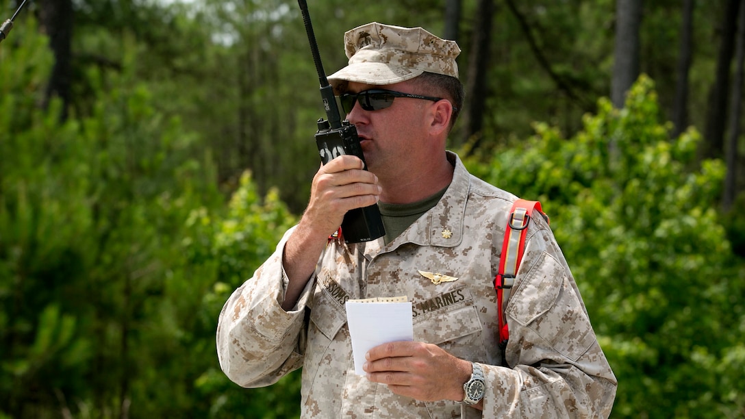 Maj. Buck Sessons, the Air Officer for Expeditionary Operations Training Group, II Marine Expeditionary Force, role-plays with pilots over a radio during a Tactical Recovery of Aircraft and Personnel course, June 10, at Marine Corps Base Camp Lejeune, N.C. For a TRAP mission, a platoon of Marines is flown into an objective area, where they locate a downed aircraft and its personnel to bring them back to safety.