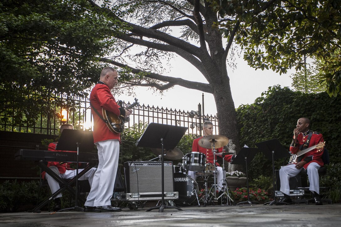 Members of the U.S. Marine Corps Band perform at a reception held at the Home of the Commandants prior to the start of an evening parade at Marine Barracks Washington, D.C., June 12, 2015. The Honoroable Mac Thornberry was the guest of honor for the parade and Ge. John M. Paxton, assistant commandant of the Marine Corps, was the hosting official for that same parade. The Evening Parade summer tradition began in 1934 and features the Silent Drill Platoon, the U.S. Marine Band, the U.S. Marine Drum and Bugle Corps and two marching companies. More than 3,500 guests attend the parade every week. (U.S. Marine Corps photo by Sgt Melissa Marnell/Released)