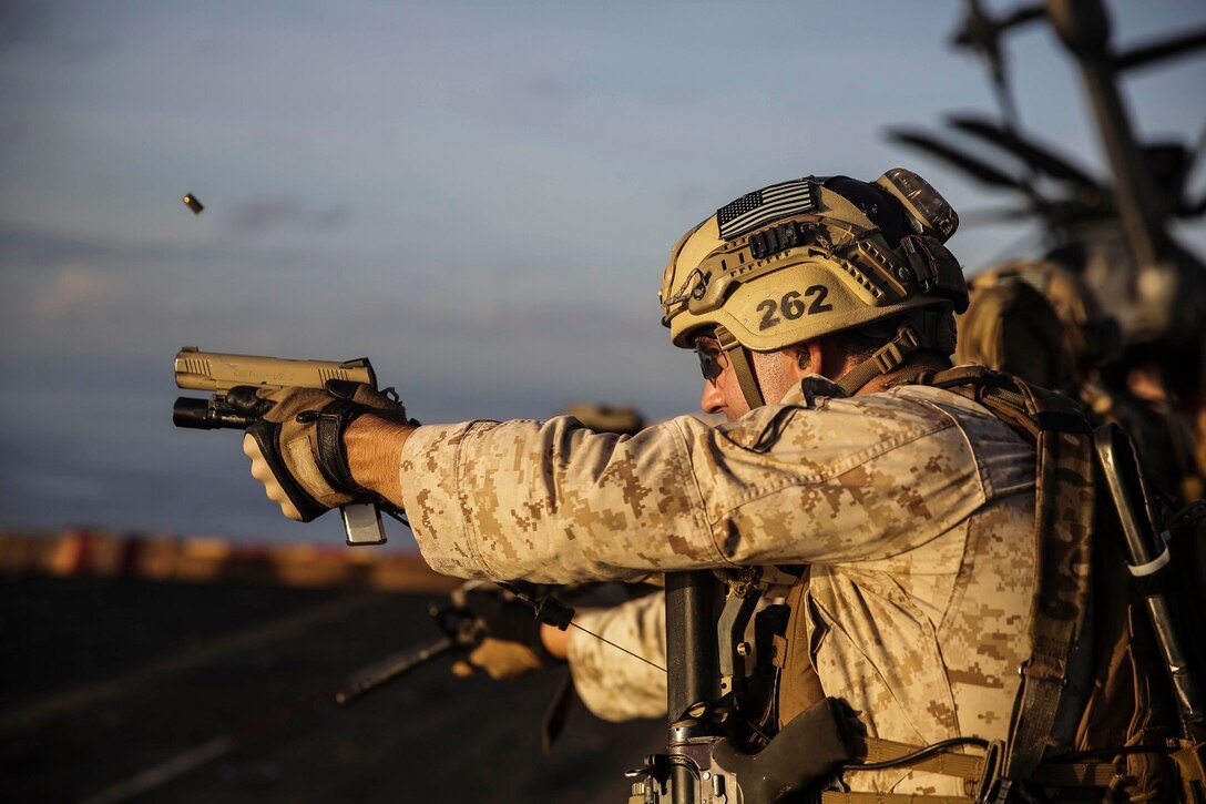 U.S. Marine Sgt. Sean Bernstein fires at his target with an M1911A pistol during a deck shoot aboard the USS Essex (LHD 2) in the South China Sea, June 12, 2015. Bernstein is a member of the 15th Marine Expeditionary Unit’s Maritime Raid Force. The MRF practices both pistol and rifle marksmanship skills frequently to improve their speed and accuracy. (U.S. Marine Corps photo by Cpl. Anna Albrecht/ Released)