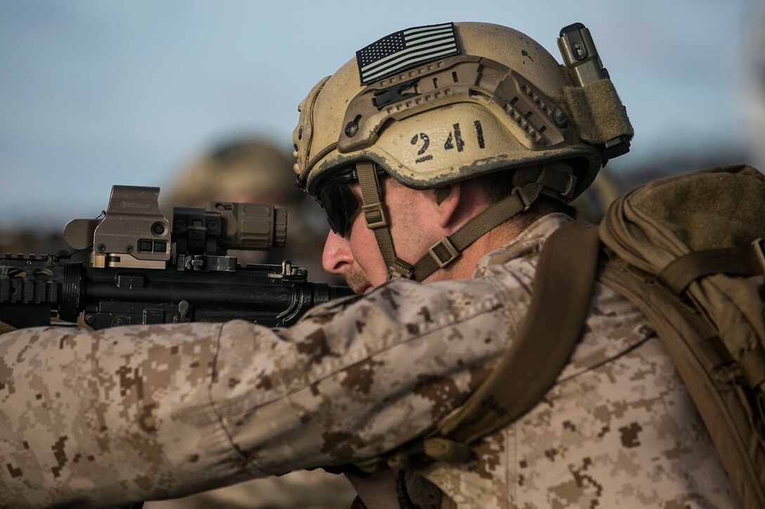 U.S. Marine Sgt. David Johnson prepares to fire at his target during a deck shoot aboard the USS Essex (LHD 2) in the South China Sea, June 12, 2015. Johnson is a member of the 15th Marine Expeditionary Unit’s Maritime Raid Force. These Marines practiced precision, slow-fire shooting, and drills which included shooting on the move and multiple target engagements. (U.S. Marine Corps photo by Cpl. Anna Albrecht/Released)