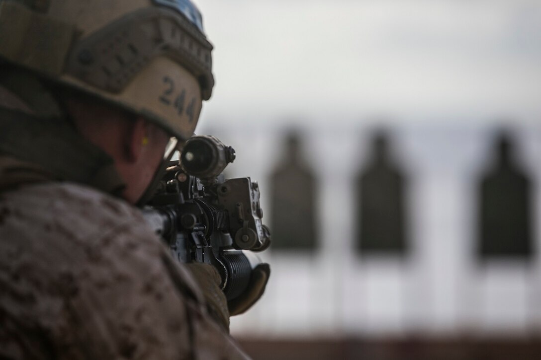 A U.S. Marine with the 15th Marine Expeditionary Unit’s Maritime Raid Force looks through his sights during a deck shoot aboard the USS Essex (LHD 2) in the South China Sea, June 12, 2015.  These Marines practice several types of shooting, such as shooting on the move, to imitate the type of engagements they would have to use in a real-life scenario. (U.S. Marine Corps photo by Cpl. Anna Albrecht/Released)
