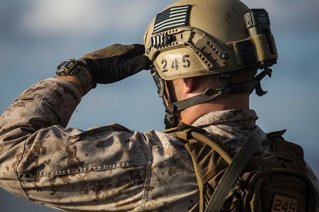 U.S. Marine Sgt. Jesse Kimble observes his target during a deck shoot aboard the USS Essex (LHD 2) in the South China Sea, June 12, 2015. Kimble is a member of the 15th Marine Expeditionary Unit’s Maritime Raid Force. These Marines practice several types of shooting, such as shooting on the move, to imitate the type of engagements they would have to use in a real-life scenario. (U.S. Marine Corps photo by Cpl. Anna Albrecht/Released)