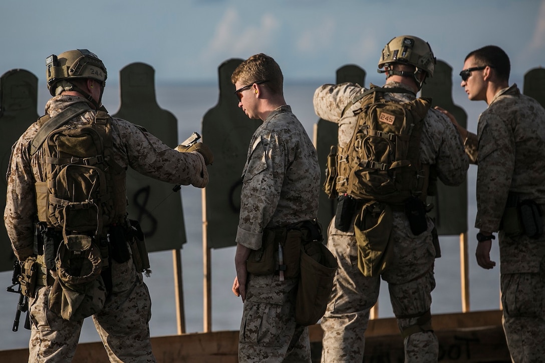 U.S. Marines with the 15th Marine Expeditionary Unit’s Maritime Raid Force clear out their weapons during a deck shoot aboard the USS Essex (LHD 2) in the South China Sea, June 12, 2015. These Marines stay precise with their marksmanship by frequently firing their weapons during different types of drills and qualifications while on ship. (U.S. Marine Corps photo by Cpl. Anna Albrecht/Released)