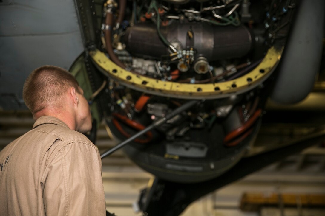 U.S. Marine Cpl. James Koepke inspects an MV-22B Osprey aboard the USS Essex (LHD 2) in the South China Sea, June 13, 2015. Koepke is a crew chief with Marine Medium Tiltrotor Squadron 161 (Reinforced), 15th Marine Expeditionary Unit. Prior to taking off, each aircraft is routinely inspected to ensure a safe flight. (U.S. Marine Corps photo by Cpl. Anna Albrecht/Released)