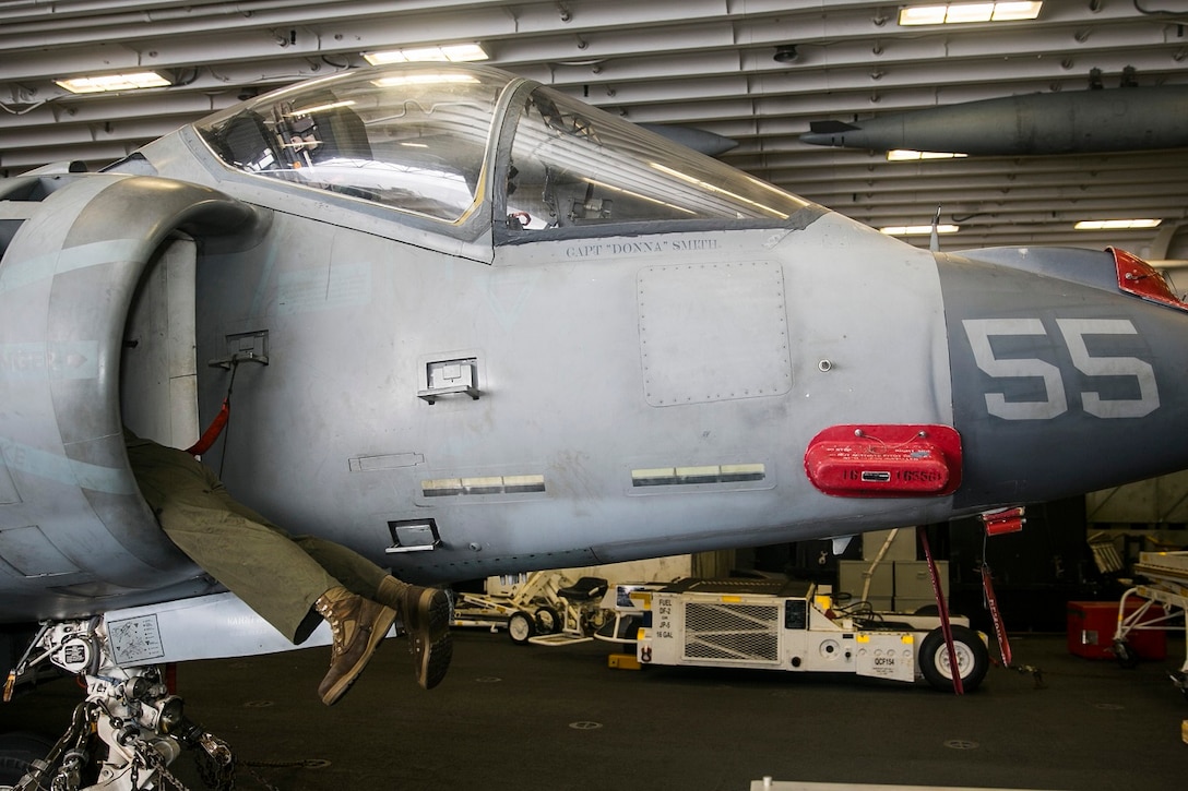 A U.S. Marine with Marine Medium Tiltrotor Squadron 161 (Reinforced), 15th Marine Expeditionary Unit, performs daily maintenance on an AV-8B Harrier aboard the USS Essex (LHD 2) in the South China Sea, June 13, 2015. These Marines work on the aircraft daily to ensure they are in good condition and ready to fly at a moment’s notice. (U.S. Marine Corps photo by Cpl. Anna Albrecht/Released)