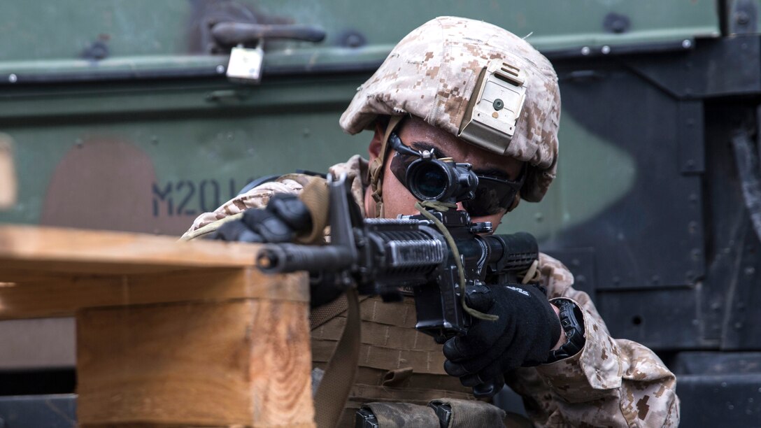 U.S. Marine Lance Cpl. Daniel Del Rio takes cover as he practices movement under fire tactics aboard USS Rushmore at sea in the Pacific Ocean, June 1, 2015. Del Rio is a rifleman with Kilo Company, Battalion Landing Team 3rd Battalion, 1st Marine Regiment, 15th Marine Expeditionary Unit. BLT 3/1 constantly trains for the unknown in order to respond to the needs of the MEU while deployed. These drills keep the Marines in a constant state of combat readiness while at sea.