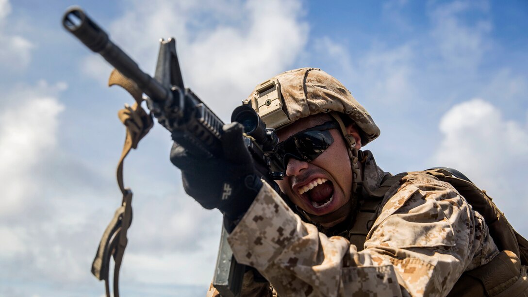U.S. Marine Lance Cpl. Daniel Del Rio shouts as he practices immediate-action drills aboard USS Rushmore at sea in the Pacific Ocean, June 1, 2015. Del Rio is a rifleman with Kilo Company, Battalion Landing Team 3rd Battalion, 1st Marine Regiment, 15th Marine Expeditionary Unit. BLT 3/1 constantly trains for the unknown in order to respond to the needs of the MEU while deployed. These drills keep the Marines in a constant state of combat readiness while at sea.
