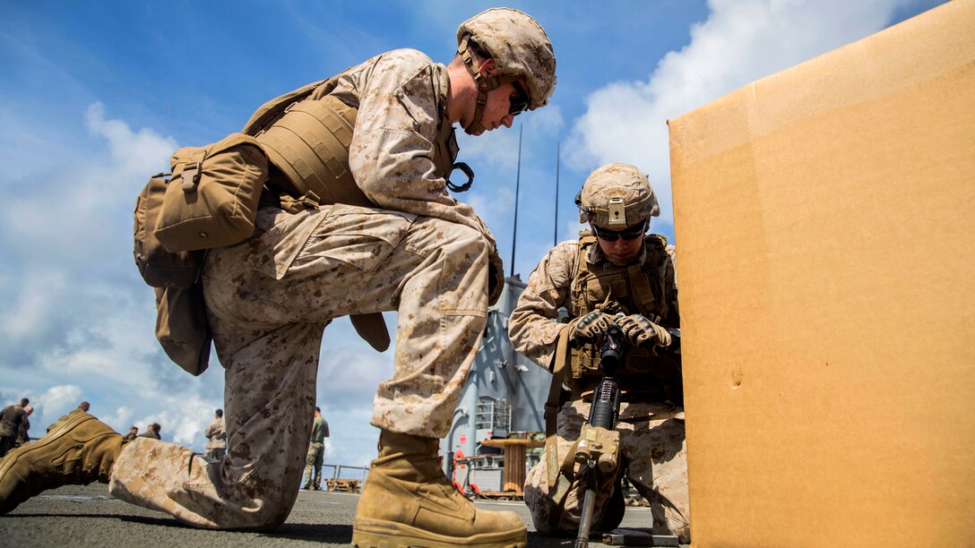 U.S. Marine Lance Cpl. Trent Martin, left, instructs Lance Cpl. Zachary Thompson during immediate-action drills aboard USS Rushmore at sea in the Pacific Ocean, June 1, 2015. Martin and Thompson are automatic riflemen with Kilo Company, Battalion Landing Team 3rd Battalion, 1st Marine Regiment, 15th Marine Expeditionary Unit. BLT 3/1 constantly trains for the unknown in order to respond to the needs of the MEU while deployed. These drills keep the Marines in a constant state of combat readiness while at sea.