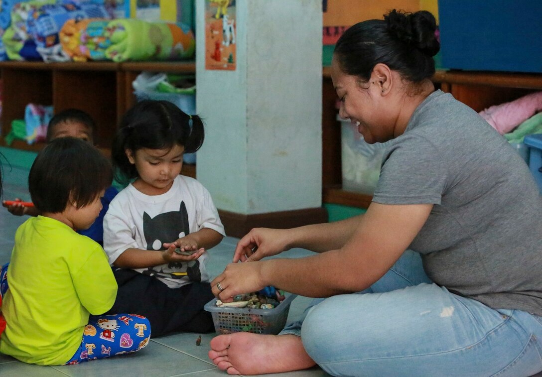U.S. Navy Logistical Support Seaman Avasina Maifea plays with children from the Fountain of Life Children’s Center in Pattaya, Thailand, June 10, 2015. Maifea is a logistical support sailor assigned to Combat Logistics Battalion 15, 15th  Marine Expeditionary Unit. Some of Marines and Sailors aboard the USS Anchorage volunteered to spend time with these children during a recent port visit in Thailand. These volunteer programs help foster better relationships with host nations throughout the 7th Fleet area of operation.  (U.S. Marine Corps photo by Sgt. Steve H. Lopez/Released)