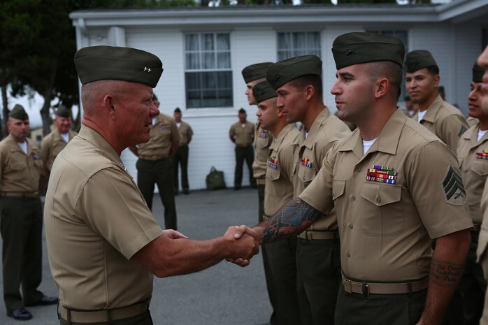 Major General Lawrence D. Nicholson, the commanding general of the 1st Marine Division, congratulates a Marine chosen from the division to attend the new Squad Leader Development Program, aboard Marine Corps Base Camp Pendleton, Calif., June 12, 2015. The program will allow qualified Marines to develop a career path as an infantry squad leader.