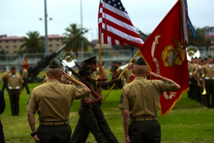 Sergeants Major David L. Jobe (left) and William T. Sowers (right) salute as the National Flag passes during a relief and appointment ceremony aboard Marine Corps Base Camp Pendleton, Calif., June 12, 2015. Sowers took charge as the senior enlisted advisor of the 1st Marine Division after completing his last assignment as the sergeant major for the Marine Corps Training and Education Command in Quantico, Va.