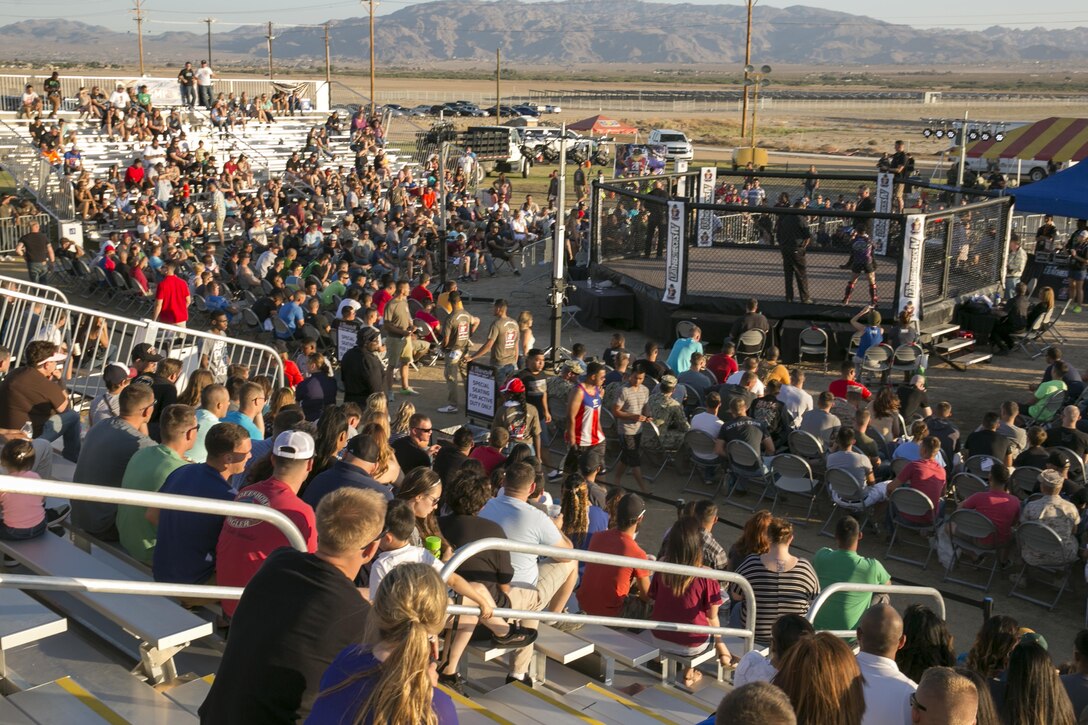 Combat Center patrons fill the stands for the Leatherneck IV Mixed Martial Arts Fight Night at Del Valle Field, June 5, 2015. The Single Marine Program organized the event and made it open to all Combat Center patrons. (Official Marine Corps photo by Pfc. Levi Schultz/Released)