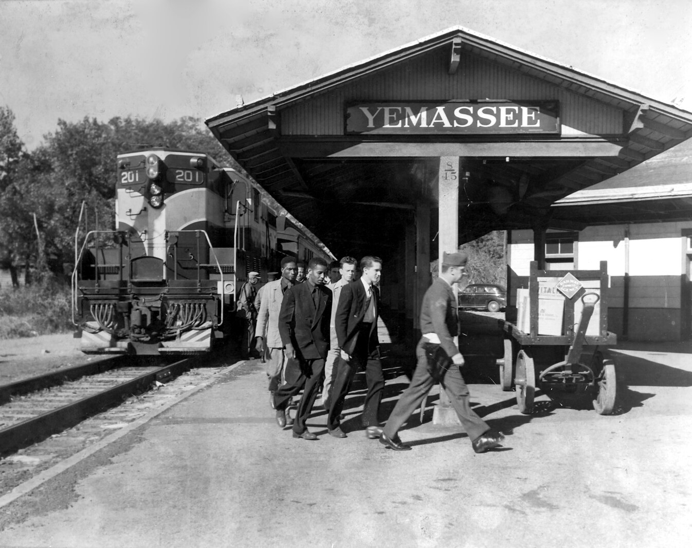 New recruits exit a train at the station in Yemassee, S.C., in the 1950's. Depending on when they arrived, the recruits would either spend the night in a barracks in Yemassee or they would be processed and sent directly to Parris Island by way of bus or cattle car. The use of the Yemassee train station ended in June 1965.