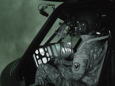 Kentucky National Guard aviators fly one of the record 36 mission runs for the Air Soldier System situational awareness technologies being tested in the Battlefield Highly Immersive Virtual Environment Laboratory. The co-pilot pictured here was assisting the pilot land the aircraft during a “brown-out” landing. A “brown-out” landing is a landing in sand and dust that creates a degraded visual environment and hinders the pilot’s ability to land the aircraft visually.