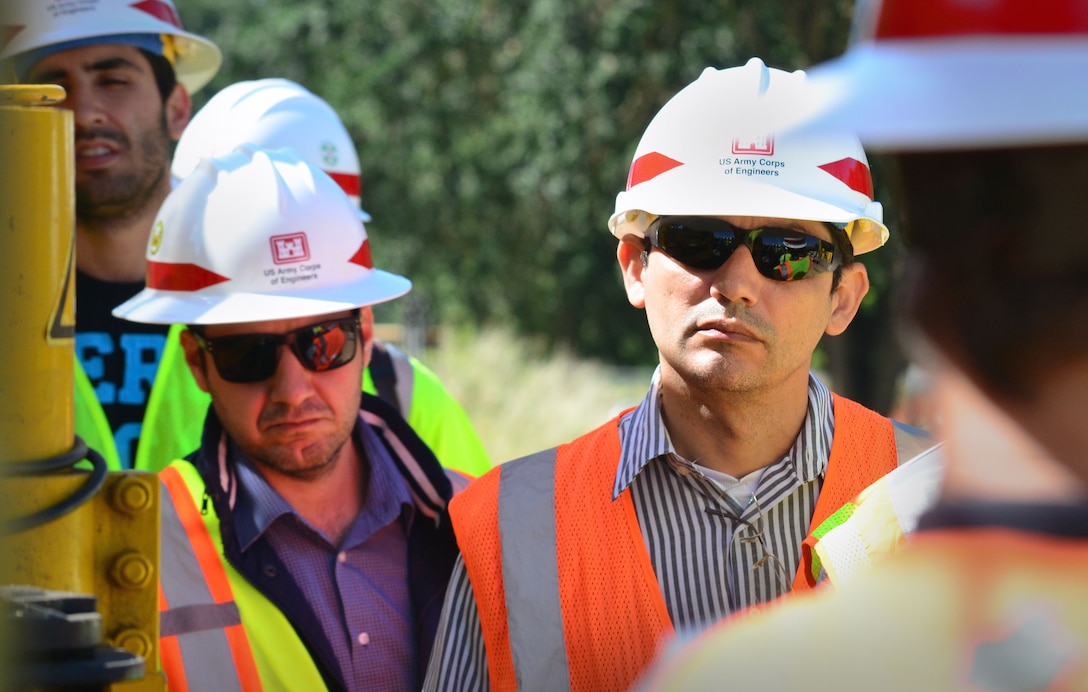 Adalberto Meller, left, and Josimar Oliveira, engineers with Agência Nacional de Águas, Brazil, visit a Corps construction site in Sacramento, California, June 3, 2015.