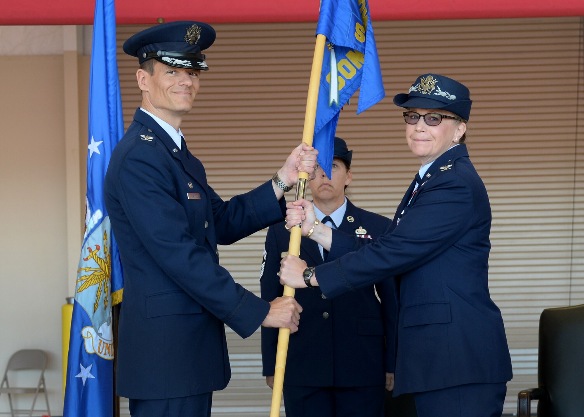 U.S. Air Force Col. Ben Maitre, 27th Special Operations Wing commander, accepts the guideon from Col. Heather Buono, 27th Special Operations Mission Support Group commander, during the 27th SOMSG change of command ceremony May 29, 2015 at Cannon Air Force Base, N.M. (U.S. Air Force photo/Senior Airman Chip Slack)  