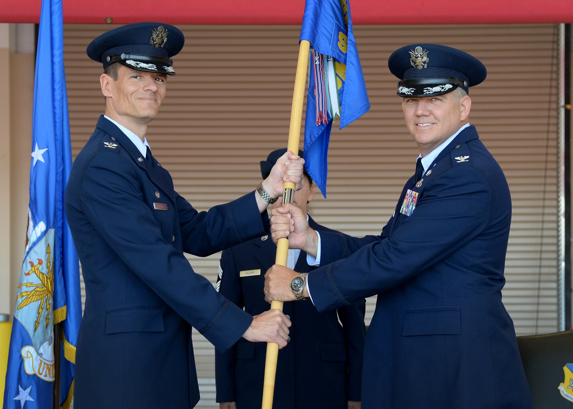 U.S. Air Force Col. Ben Maitre, 27th Special Operations Wing commander, hands the guideon to Col. Douglas Gilpin, 27th Special Operations Mission Support Group commander, during the 27th SOMSG change of command ceremony May 29, 2015 at Cannon Air Force Base, N.M. Gilpin will oversee six diverse squadrons, all geared toward providing base support and services activities to ensure mission readiness of the 27th SOW. (U.S. Air Force photo/Senior Airman Chip Slack)  