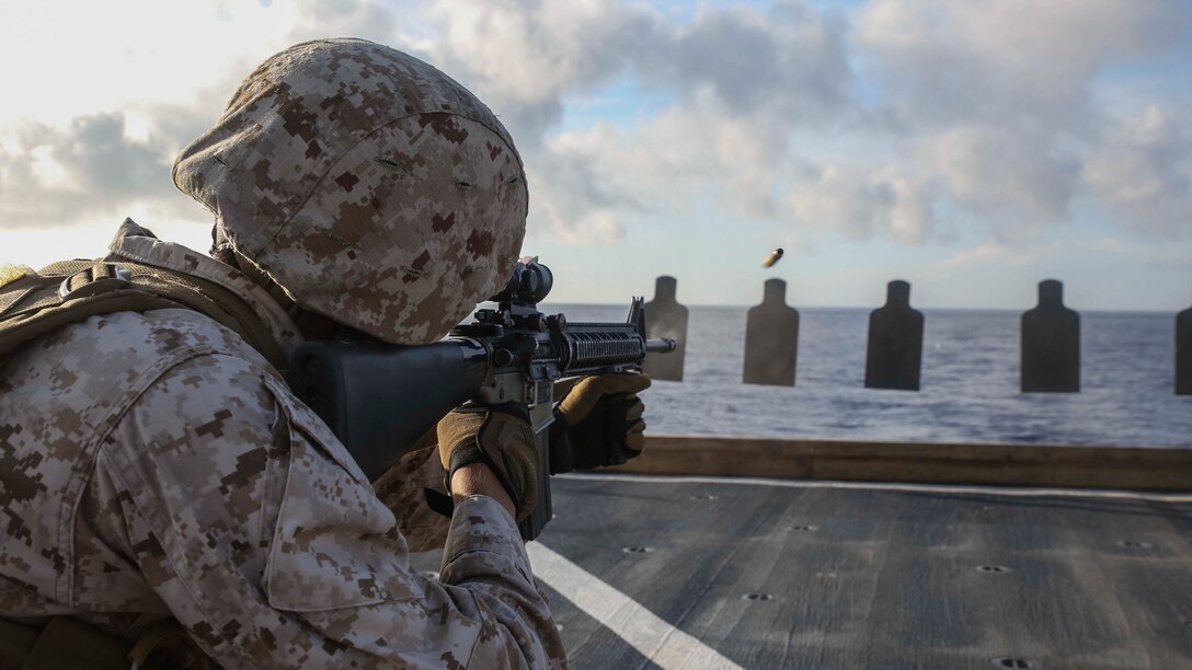 A U.S. Marine participates in a combat marksmanship program range on the flight deck of the USS Ashland (LSD 48) June 12, 2015. The Marines honed their skills by executing several different shooting techniques. The Marines are with Echo Company, Battalion Landing Team 2nd Battalion, 5th Marines, 31st Marine Expeditionary. The 31st MEU is currently deployed on the regularly scheduled Fall Patrol of the Asia-Pacific region. 