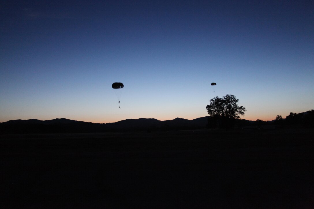 Marines from 4th Force Reconnaissance Company, 4th Marine Division, Marine Forces Reserve, conduct parachuting operations during their drill weekend at Fort Hunter Liggett, California, May 2, 2015. The drill period included parachuting operations, observation and report exercises, and included a surprise visit from Marine World War II Veteran, Bill Darling. (Photo courtesy of 4th Force Reconnaissance Company)