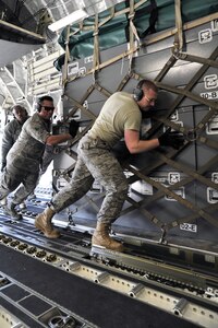 Airmen from the 89th Aerial Port Squadron load pallets onto a C-17
Globemaster III, March 12, 2011, at Joint Base Andrews, Md. Air
transportation Airmen from the 89th Aerial Port Squadron at Joint Base
Andrews created 14 pallets of technical search and rescue gear, to include
inflatable swift-water rescue boats, generators, trench rescue and cutting
equipment. The gear was being transported by C-17 to more than 80 Fairfax
County Urban Search and Rescue technicians to provide assistance in the
rescue effort after an earthquake and tsunami hit Japan on March 11.