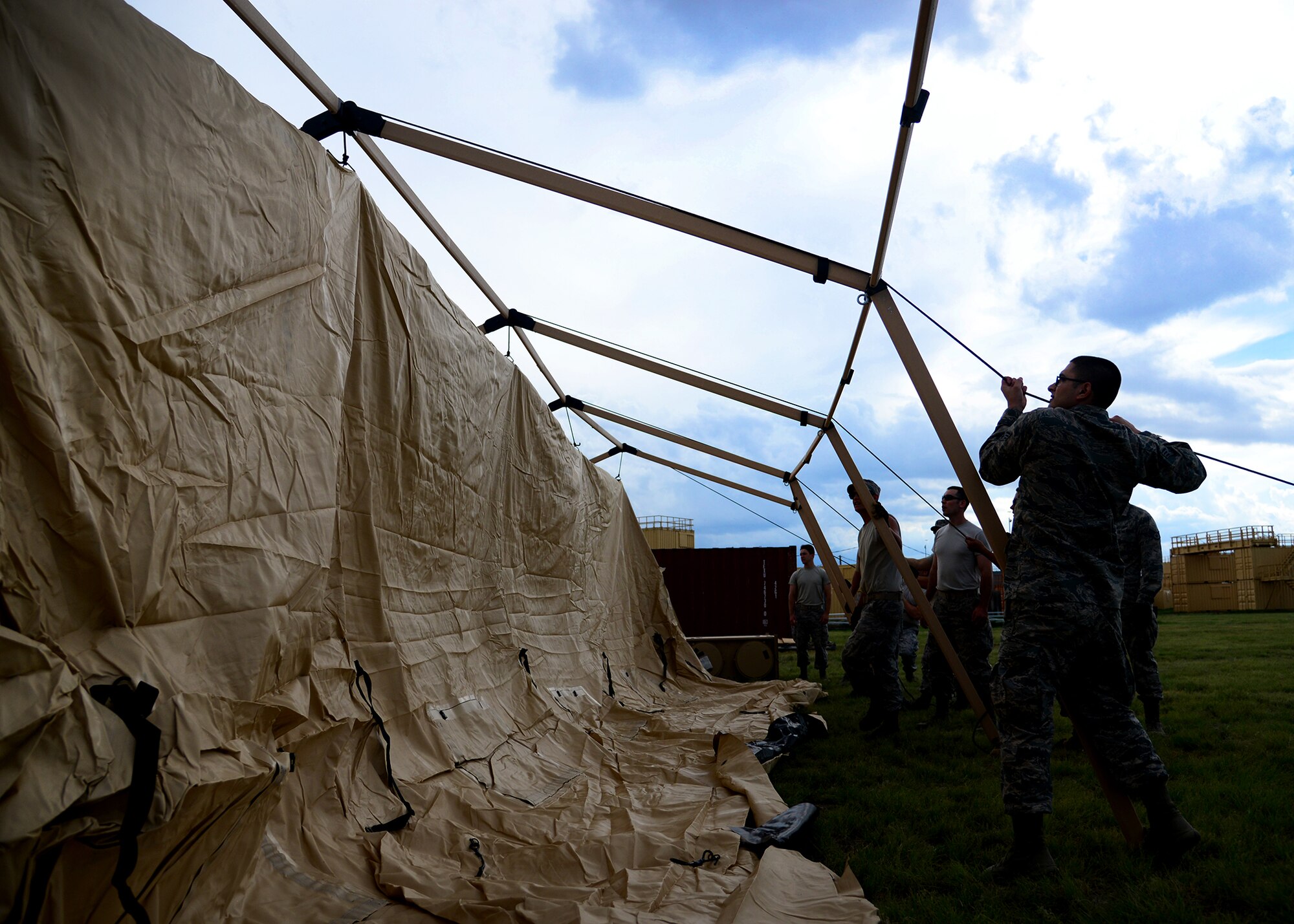 Members of the 27th Special Operations Contracting Squadron and 27th Special Operations Comptroller Squadron set up tents and organize equipment during an exercise June 8, 2015 at Melrose Air Force Range, New Mexico. During the exercise, finance and contracting Air Commandos received financial training and practiced managing contracts and contract personnel in a contingency environment. (U.S. Air Force photo/Senior Airman Chip Slack)